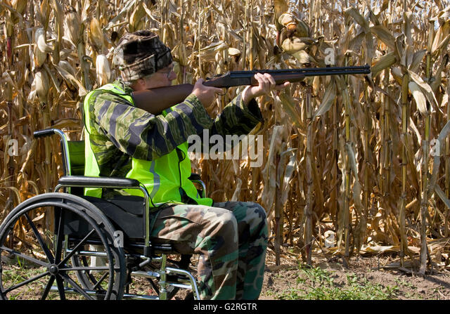 disabled-hunter-in-a-safety-vest-shooting-a-shotgun-in-a-corn-field-g2rgtr.jpg